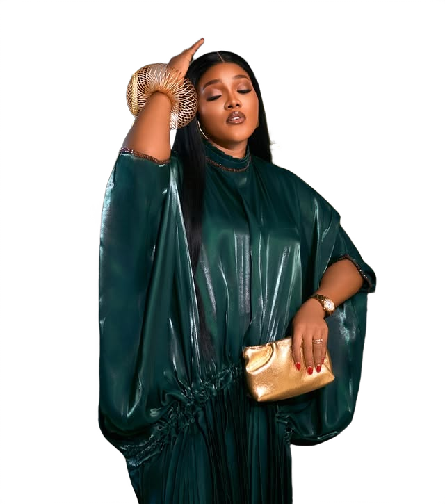Model wearing an emerald satin gown with gold accessories